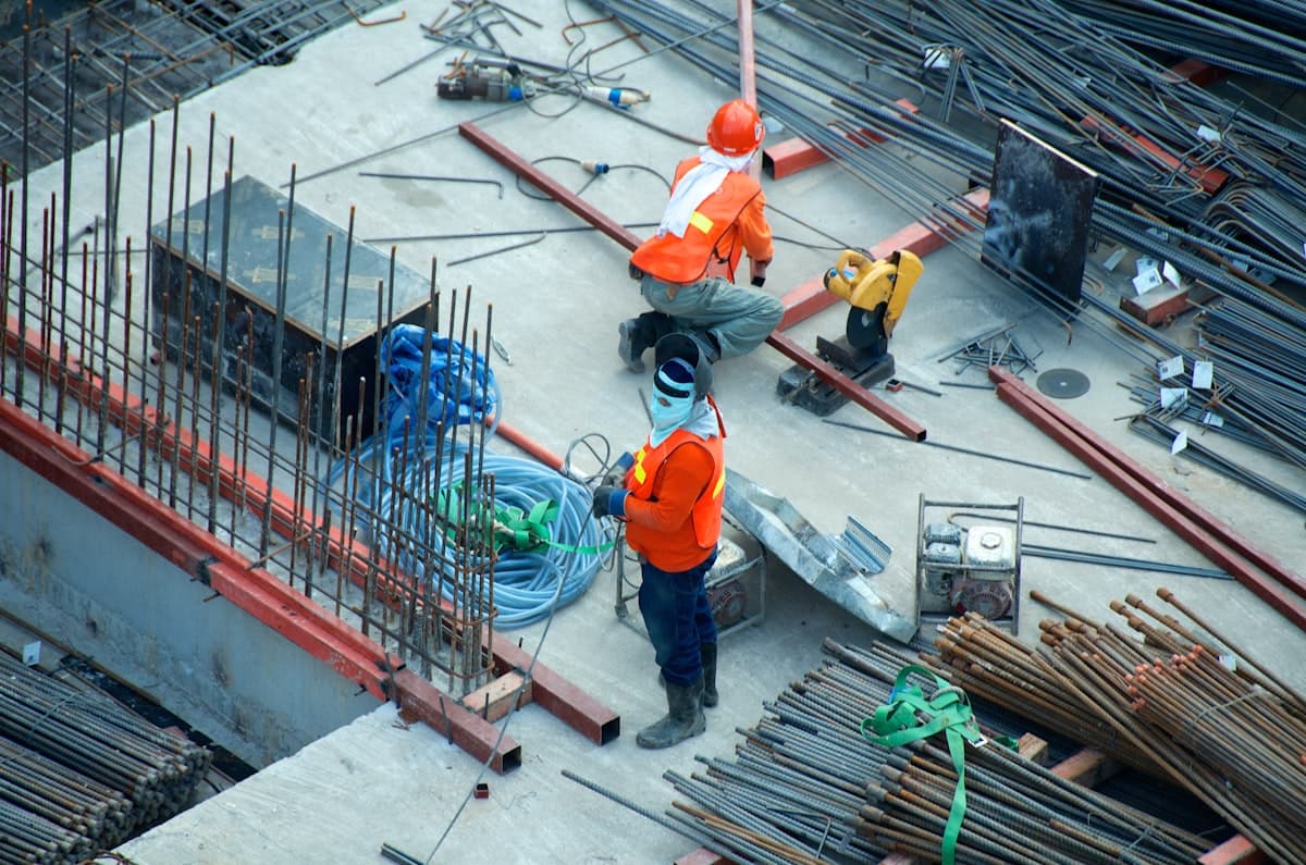 Two construction professionals reviewing project drawings together on site